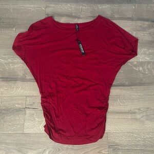 Woman’s blouse with rouched elastic sides. Modal material new with tags .